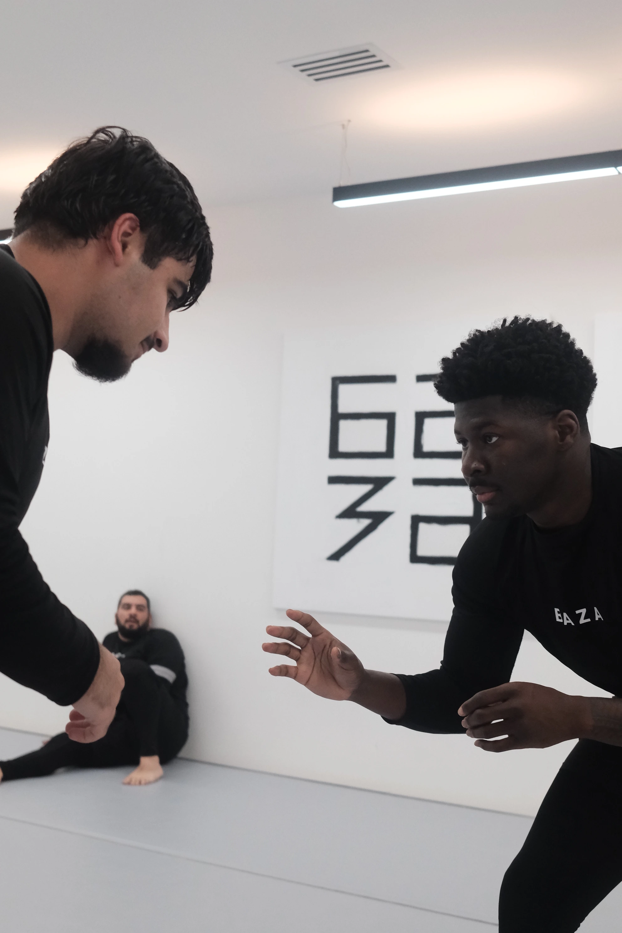 Two adult students training no-gi Brazilian Jiu-Jitsu at BAZA